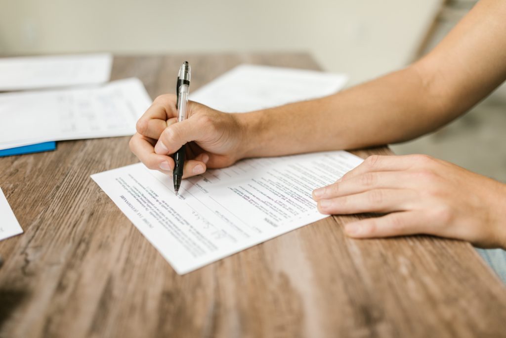 Picture of a Person Filling Out a Form
