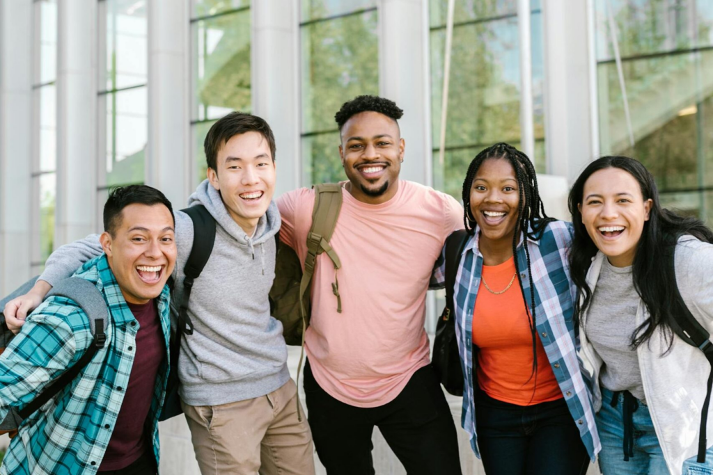 Photo of a diverse group of students standing outdoors on campus.