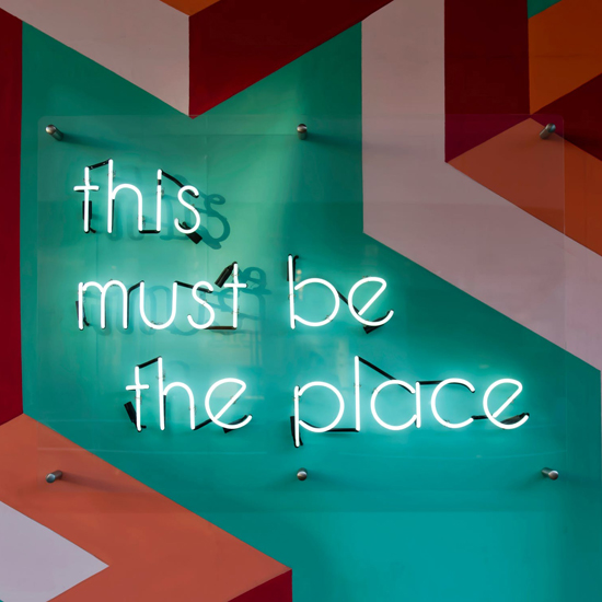 photo of a neon sign saying "this must be the place"