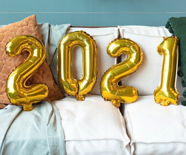 photo of balloons making 2021 against a backdrop of pillows