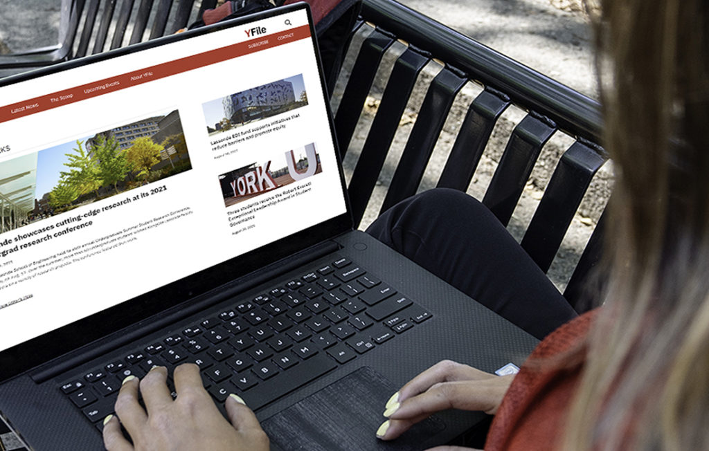image of a woman viewing a webpage sitting outdoors on a bench