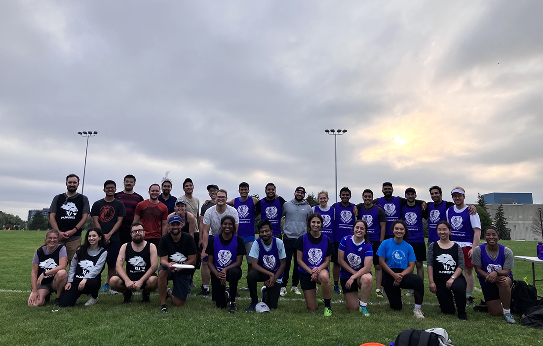 photo of the Grad Sports League participants taken on an outdoor playing field