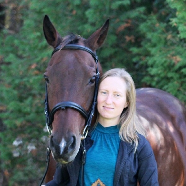 Fiona Patterson with a horse looking over her shoulder
