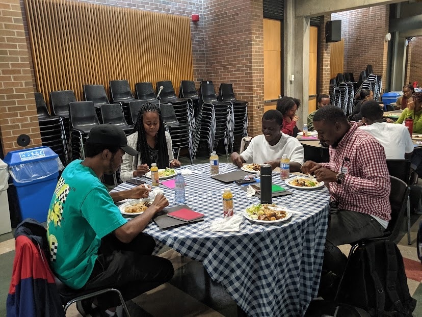 four people discussing shared experiences over a meal