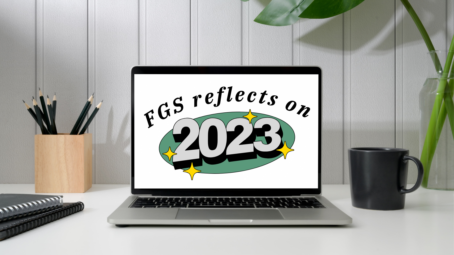 computer on a desk with the words "FGS reflects on 2023" on the computer screen