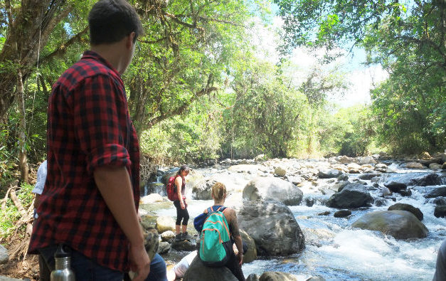 Students by a stream of river