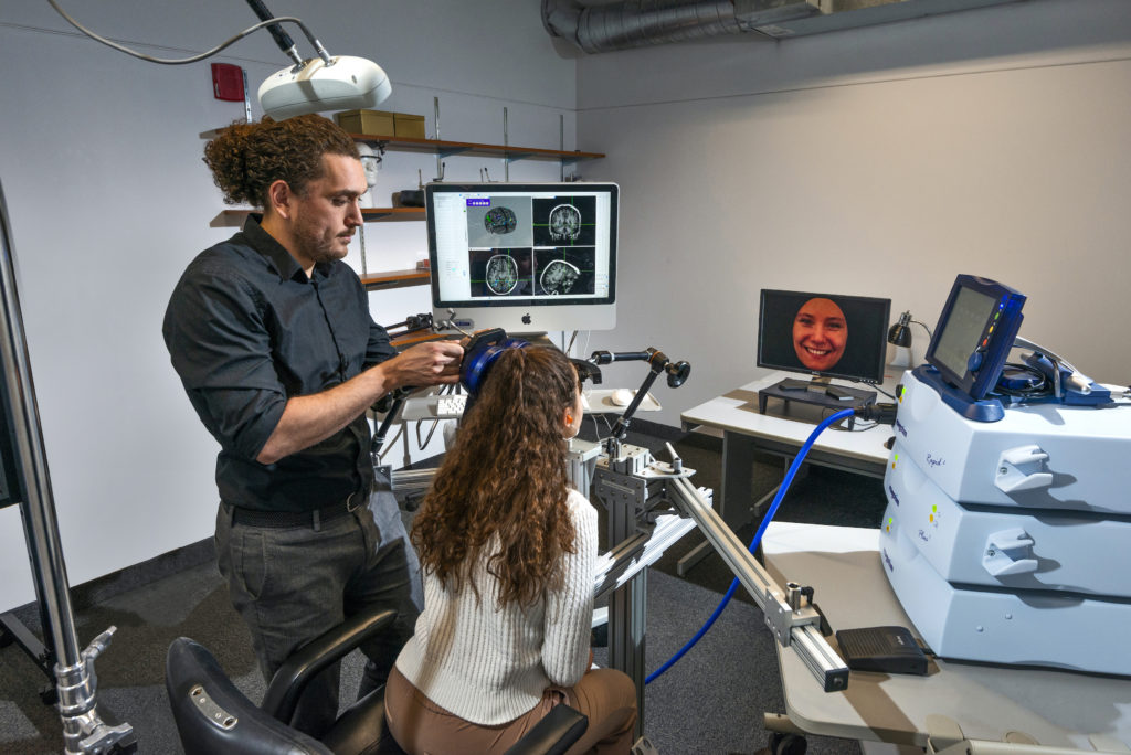 An image of students in the lab using the Magstim (TMS) system