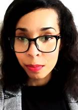 Angelique Gordon,  a close up of Black woman with glasses smiling