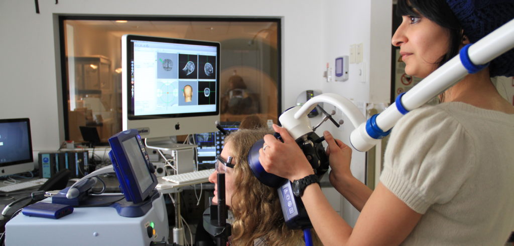 Psychology student performing a brain scan on another student