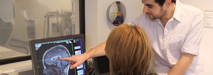 Two researchers analyzing a brain scan in the MRI lab