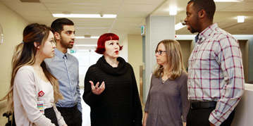 Health Studies professor speaking to students in a hospital