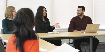 Psychology students talking in a classroom