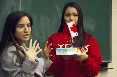 Two students giving a presentation.