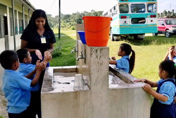 Global Health student helping children wash their hands