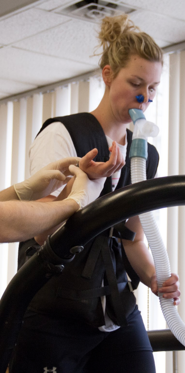 Person a treadmill with breathing tube during Kinesiology research