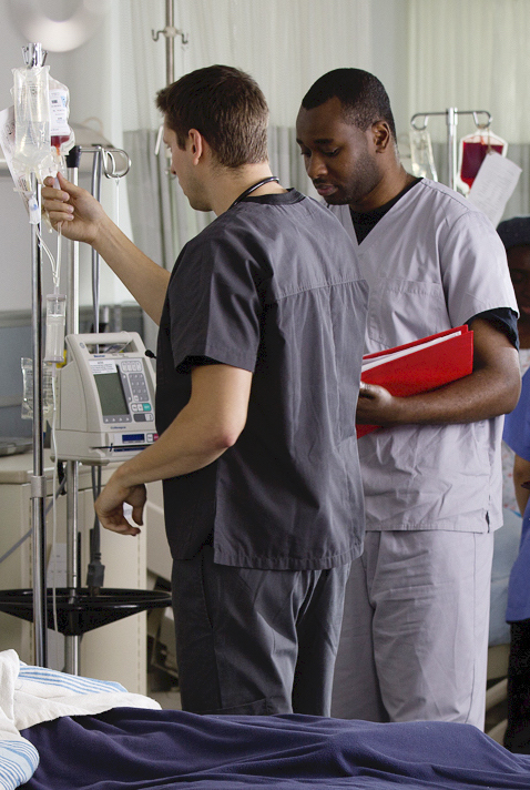 Nurses by a hospital bed