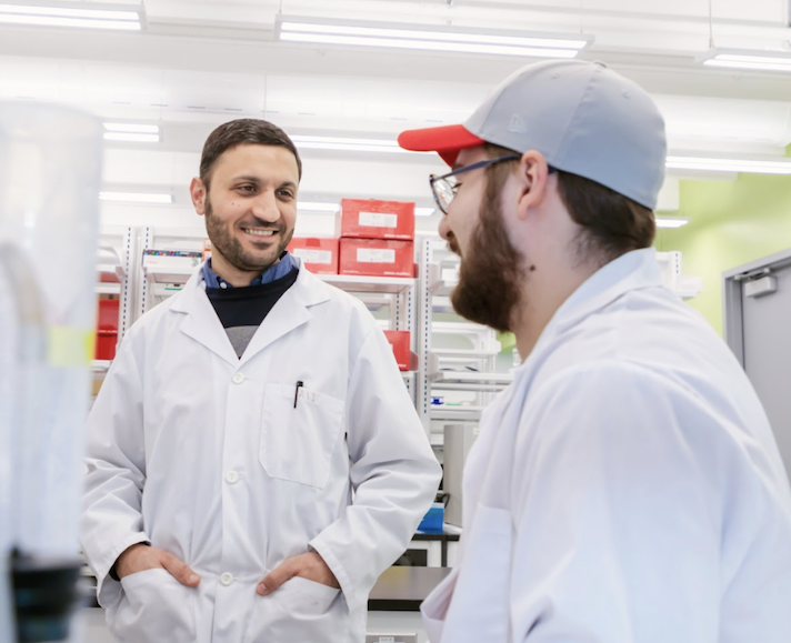 Two students talking in a lab