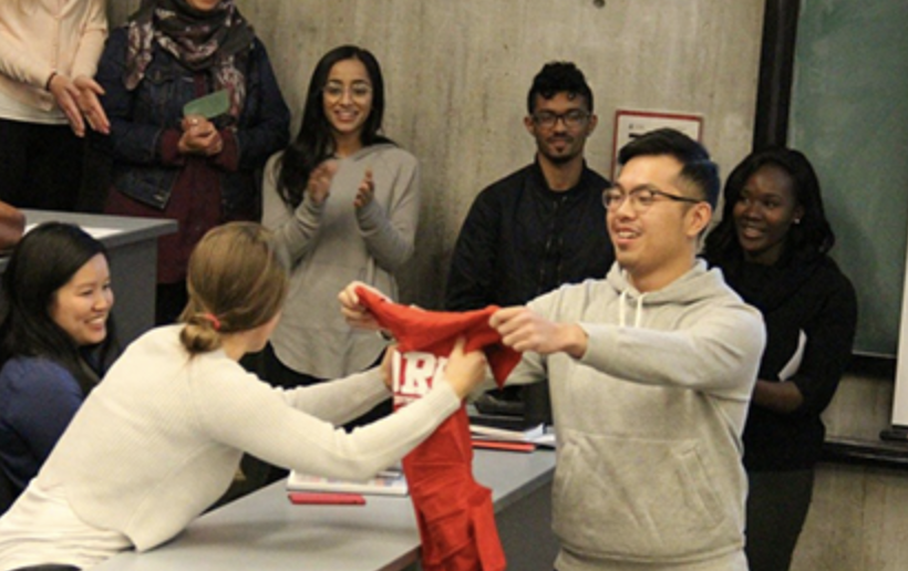 Student giving another student a York University t-shirt.