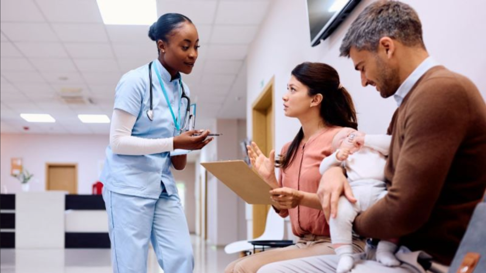 Nurse speaking to parents in a hospital