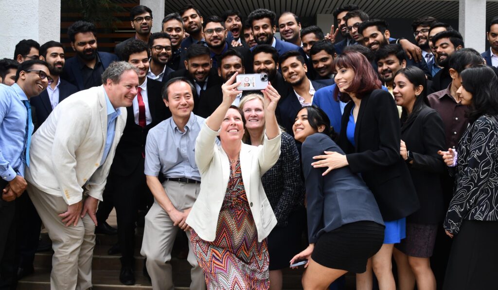 York University executive team taking a selfie with students in Indian