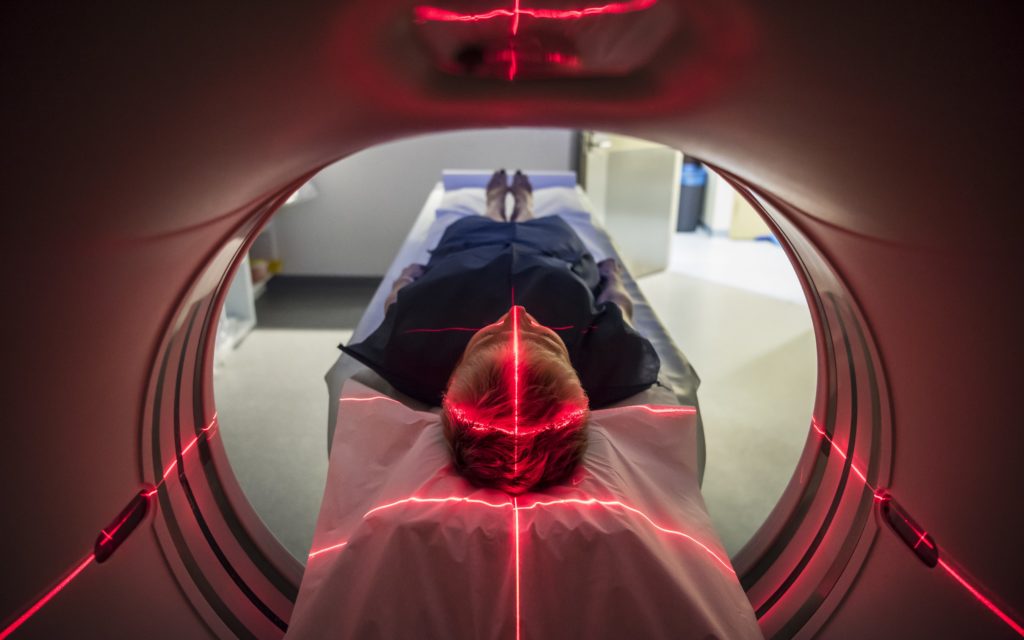 Image of a patient lying inside a medical scanner in hospital