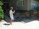 Scott Young, showing foundation of house affected by beach erosion, N. Shore of Maui, Speckesville beach