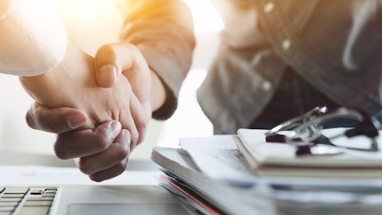 close up of people shaking hands