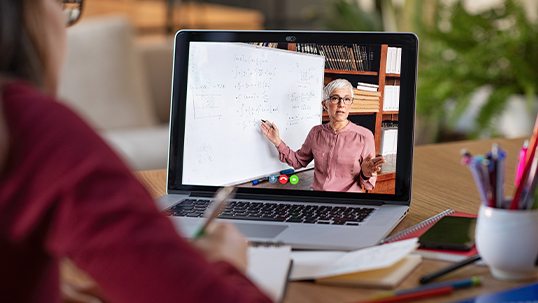 Student viewing lecture from professors on their laptop