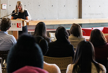 Female lecturer does a presentation to a crowd at York University
