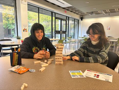 two students playing jenga