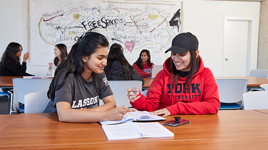 two female students studying in a clasroom