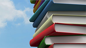 stacked books with sky in the background