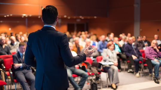 A man speaking at a business conference