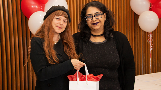 Student and professor pose for photo during award gala