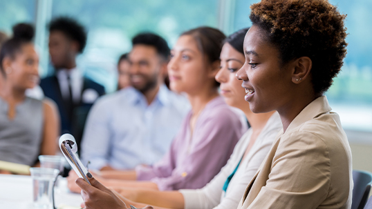 focus on young black woman in seminar with her peers