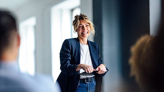 woman smiling in front of students