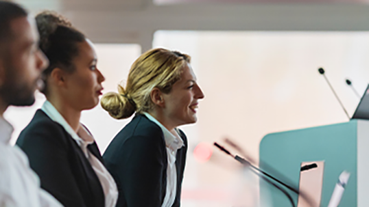 three speakers at table