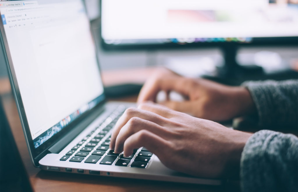 close up of person typing on laptop