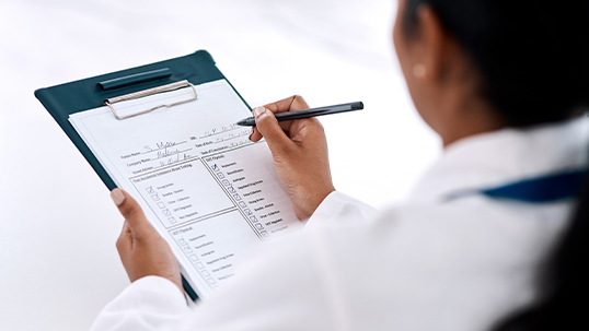 young woman fills in checklist on clipboard