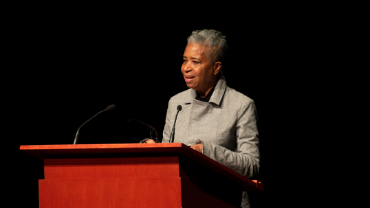 Black woman speaking at podium