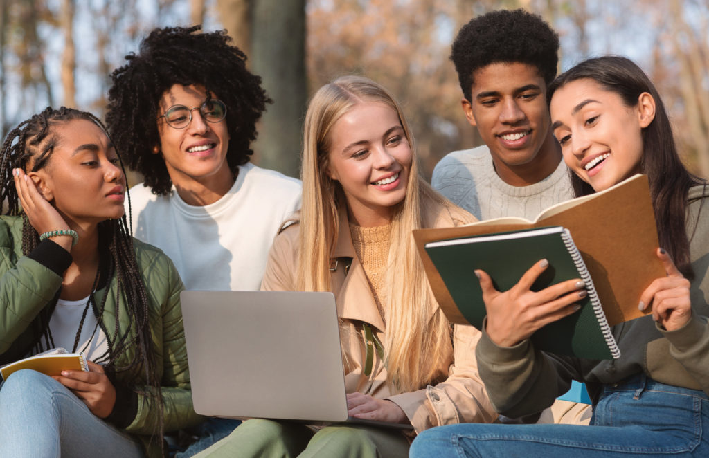 Group of happy students studying