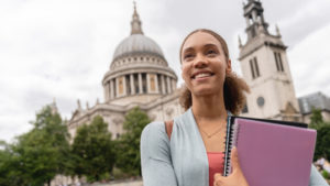 Student smiling with St. Paul's Cathedral in the background