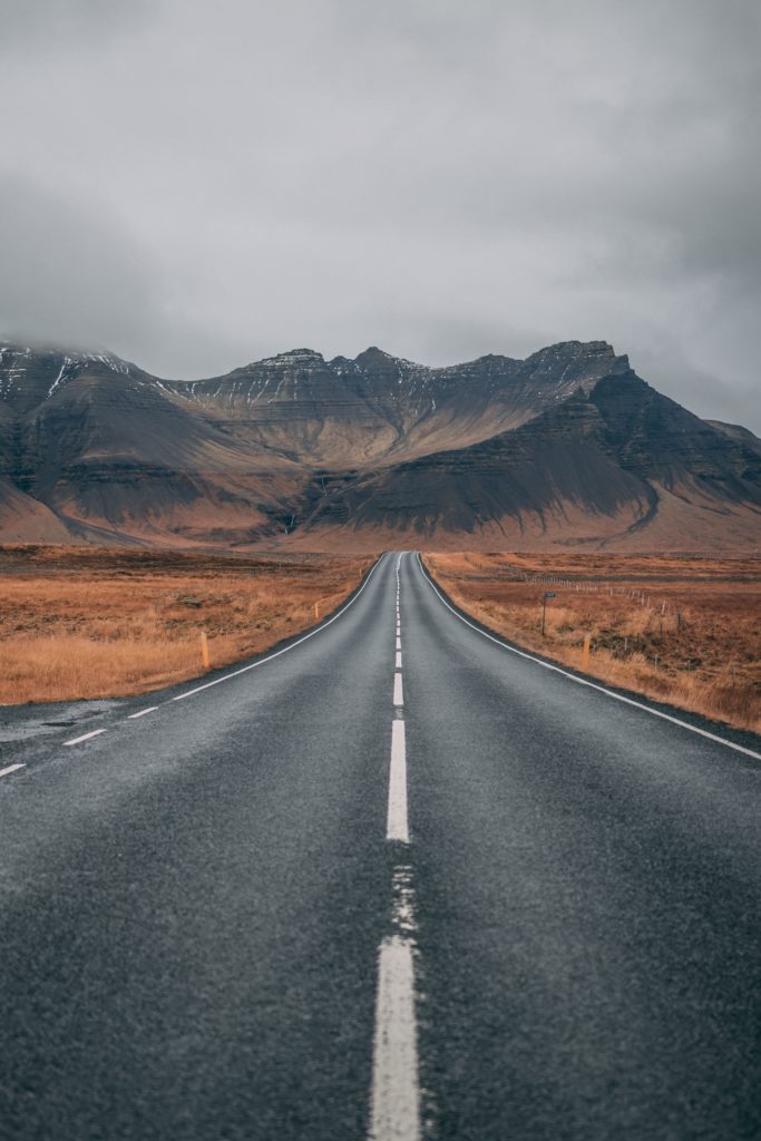 Image of a road with the mountains in the background