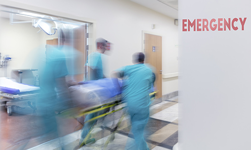 Doctor wheeling patient