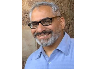 Sociology professor discusses how better digital literacy could mitigate conspiracy theories in article for The Conversation S. Harris Ali headshot