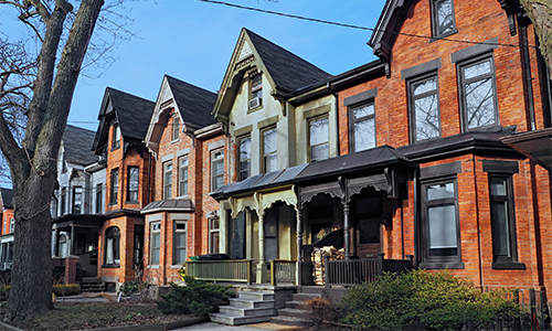 Row of old Victorian style brick houses with gables