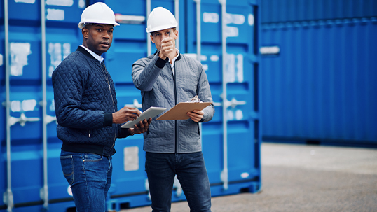 two men in hardhats at storage site