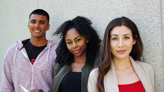 three students smiling for camera