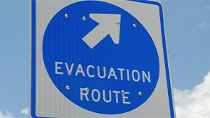 A blue sign indicating an evacuation route for residents.