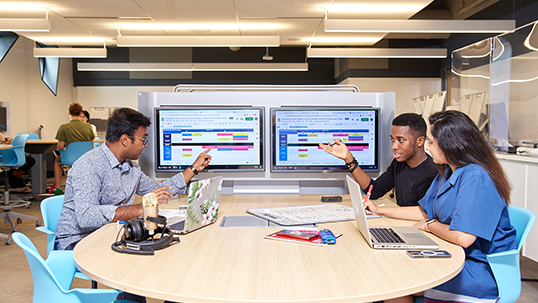 students sitting at the desk in the classroom